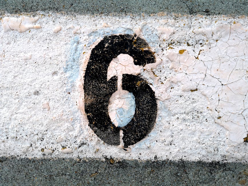 Stencil number six on pavement representing foundational strength